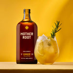 A bottle of Mother Root Ginger from Mother Root sits next to a glass of iced ginger drink with apple cider vinegar and rosemary, all set against a bright yellow background.